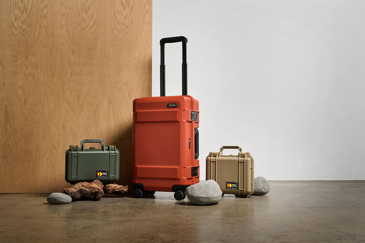 Peli ATX HC22 carry-on suitcase being wheeled through a travel setting